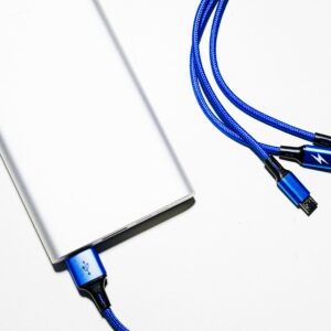 Minimalist image of a power bank with blue USB charging cables on a white background.